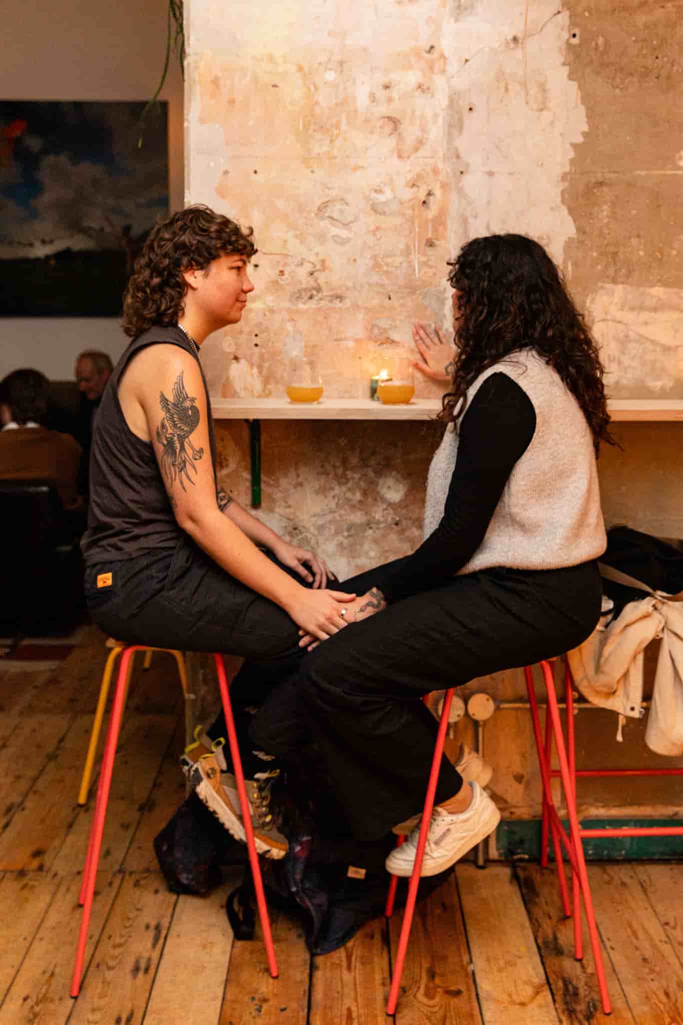 Two people talking at table by Ellen Richardson